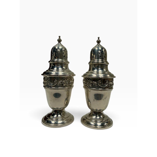 A highly elegant, complete pair of solid sterling silver salt and pepper shakers (muffineers) by the legendary American...