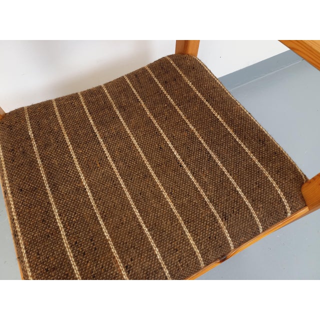 Vintage armchair from the 80s, in pine wood and ecru and praline brown striped wool fabric. Very original flared design on...