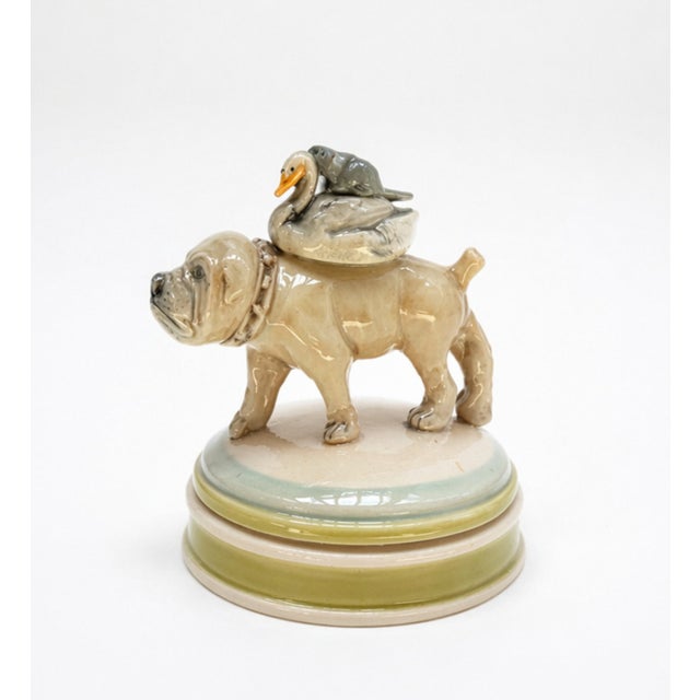 Lidded Container – Bull Dog with Friends transforms a functional porcelain vessel into a whimsical sculptural scene,...