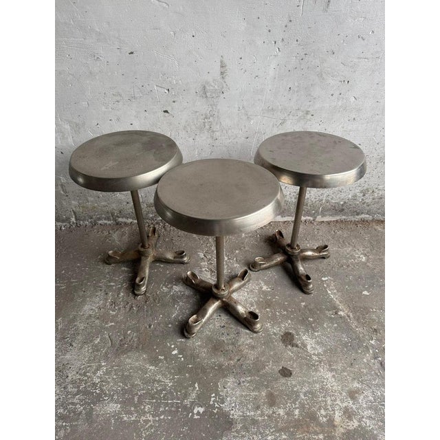 Industrial-Style Metal Side Table This sleek and sturdy side table features a round metal top with an industrial finish,...