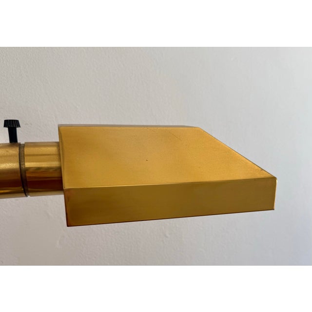 1980s Art Deco Revival banker's desk lamp on a double plinth separated by ball feet. Handsomely attired with shiny brass...