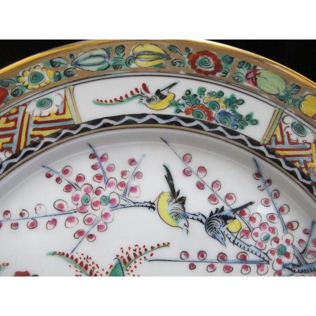 Japanese 20th century porcelain plate, measures 10 1/4". White porcelain hand painted in bold tones showing 5 roosters...