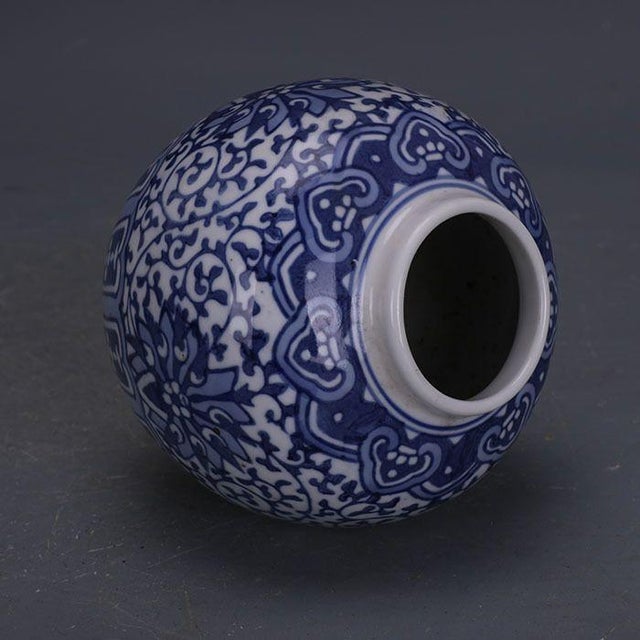 Add a touch of timeless elegance to your home with this vintage blue and white porcelain jar. This decorative vessel...