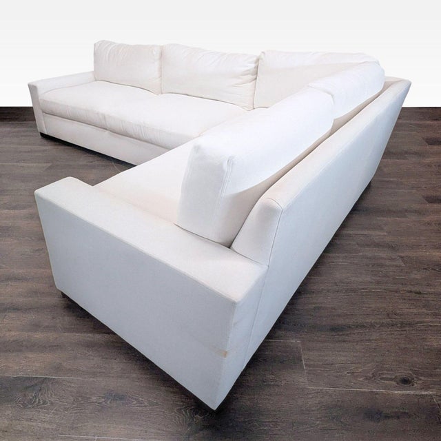 This Restoration Hardware sectional offers stylish comfort with its clean, modern lines and soft white upholstery. The...