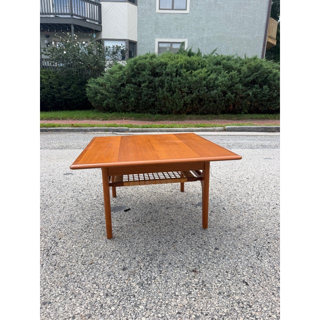 Mid century teakwood side table by Trioh. The table features a nice lower canning tier that adds to its aesthetic. The...