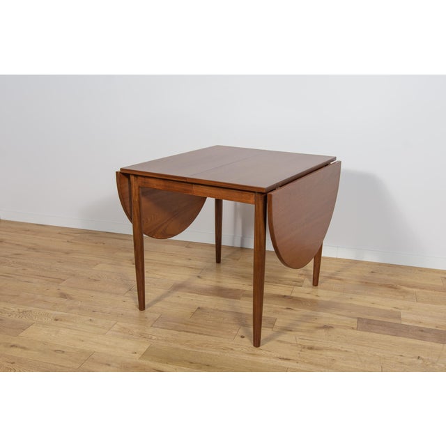 This square, extendable teak table was manufactured in Denmark in the 1960s. It has undergone a comprehensive carpentry...