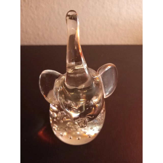 This is a Clear Art Glass Bullicante 5" Trunk Up Elephant Paperweight Procured at auction