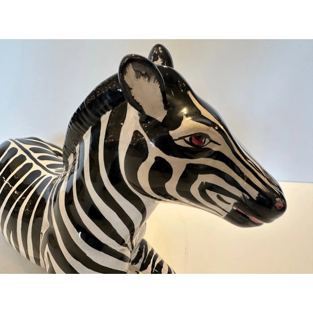 Striking glazed terracotta sculpture of a recumbent zebra from Italy.