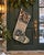 This one-of-a-kind Christmas stocking is hand-altered from an authentic vintage Turkish rug, hand-knotted in wool circa...