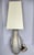 A beautifully crafted Italian porcelain table lamp by Mangani, featuring a striking sculptural nautilus shell silhouette...