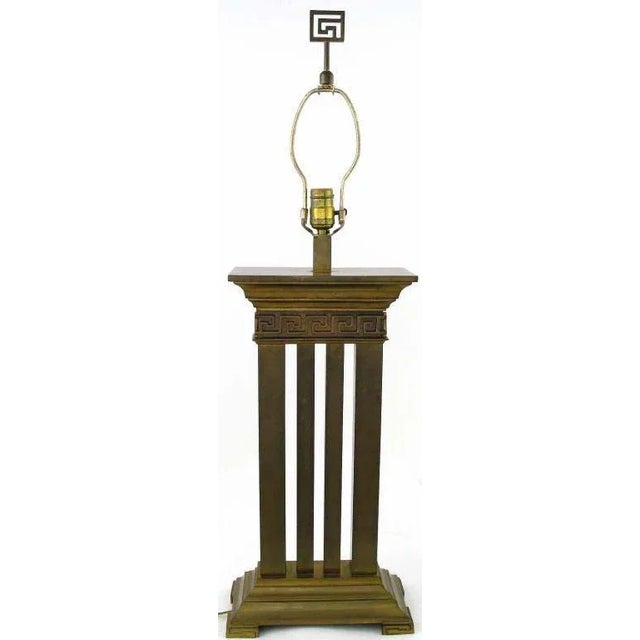 Architecturally refined Greek revival table lamp in bronze with columns and Greek key detail. Stylized Greek key finial....