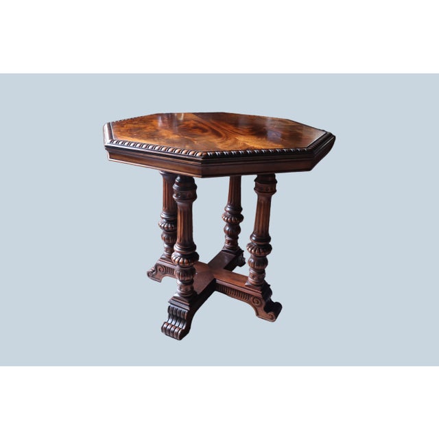 Gorgeous mahogany center table with gorgeous mirrored wood grain on the top surface. The legs of the table are a sturdy...