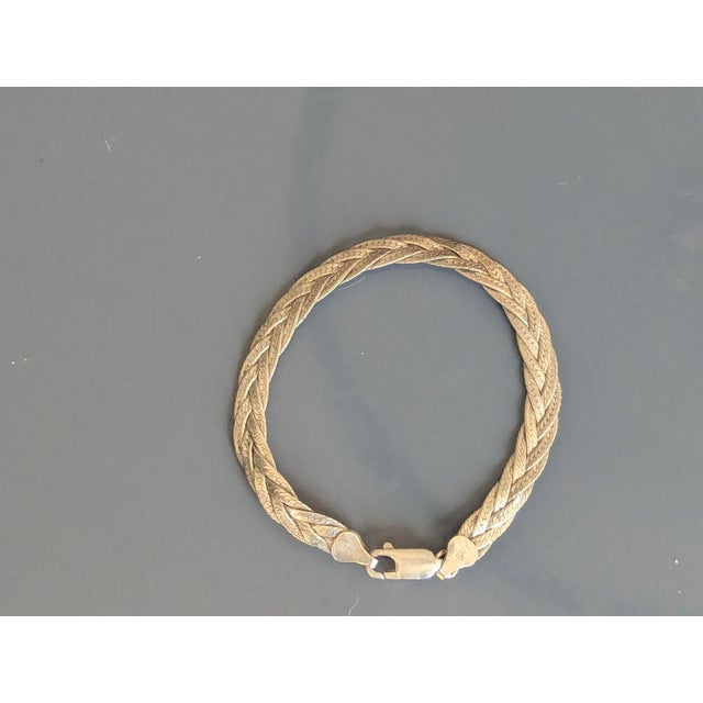 Delicate and intricate in appearance, this is Italian silver with a braided herringbone chain. This bracelet is very...