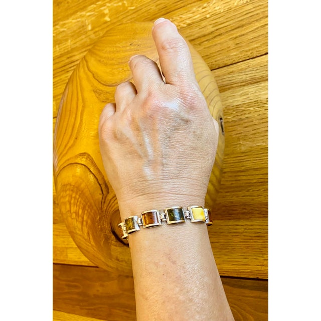 Multi-color amber and sterling silver link bracelet. Rectangle-shaped genuine Baltic Amber, curved top stones set in .925...