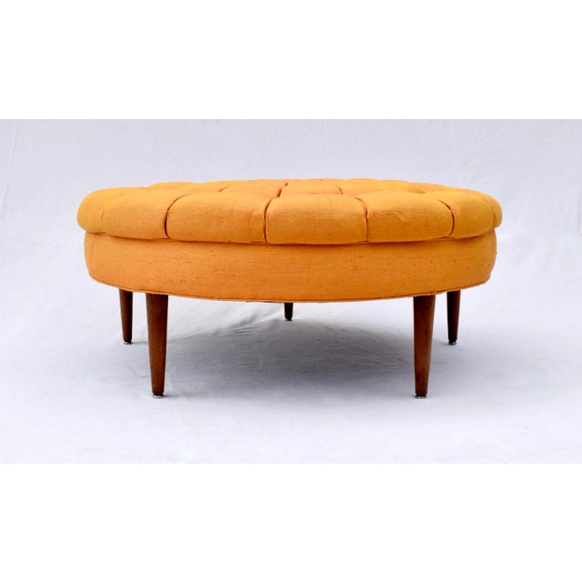 An unusual custom Mid Century Modern tufted ottoman in vibrant Sunflower raw silk upholstery with Walnut tapered legs....