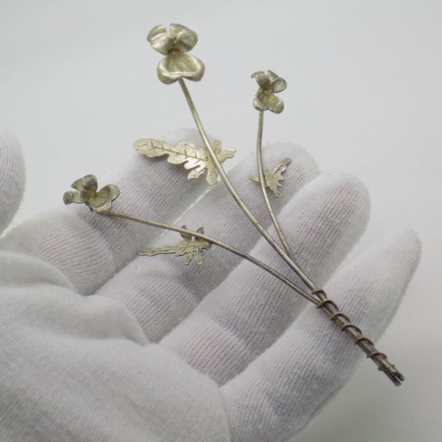 A long vintage miniature depicting an orchid branch, handcrafted in Continental Silver (800/000) in Italy between the...