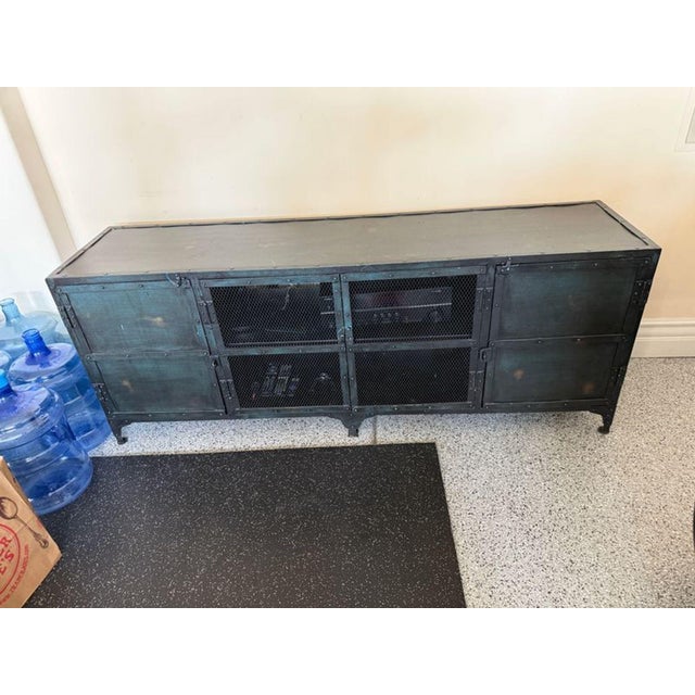 This Restoration Hardware sideboard offers strong industrial style with a sturdy metal frame and mesh doors. It provides...
