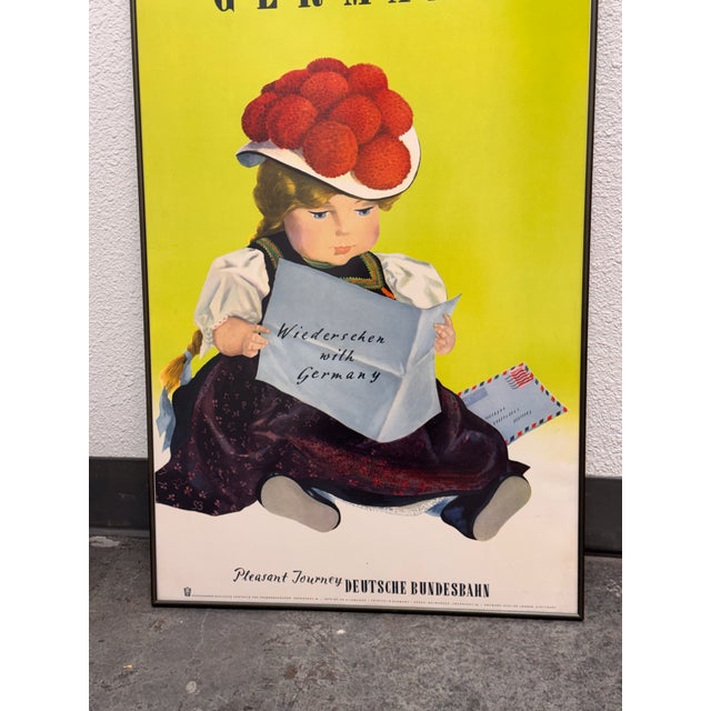 Design Plus Gallery presents a Framed Poster “Wiedersehen with Germany” by Hanns Lohrer. This vintage-style travel poster...