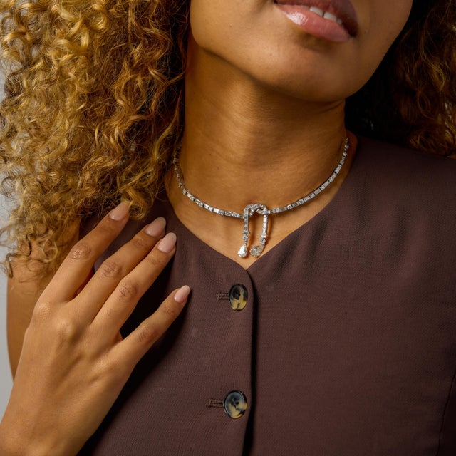 This Mid-Century diamond cocktail necklace is a striking testament to postwar glamour, where scale, precision, and...