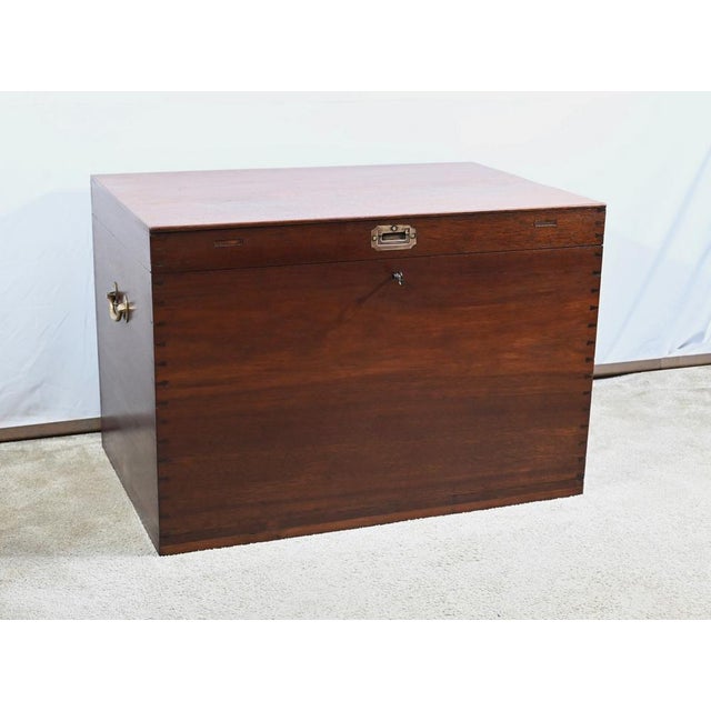 This large teak trunk is composed of solid planks without joints on the top, sides, back, and front, assembled with...