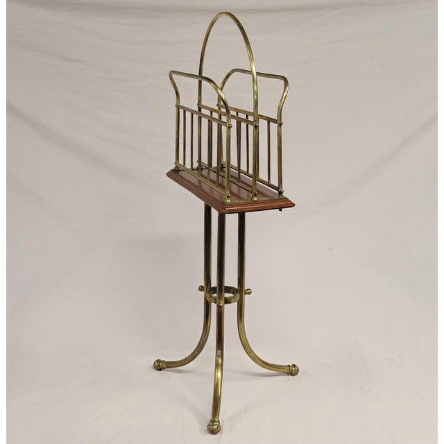 A charming antique Edwardian oak and brass standing magazine holder. The brass and wood have a beautiful aged patina. All...