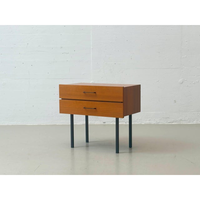 An elegant 1960s nightstand with clean lines and a balanced combination of materials. The compact body, finished in a warm...