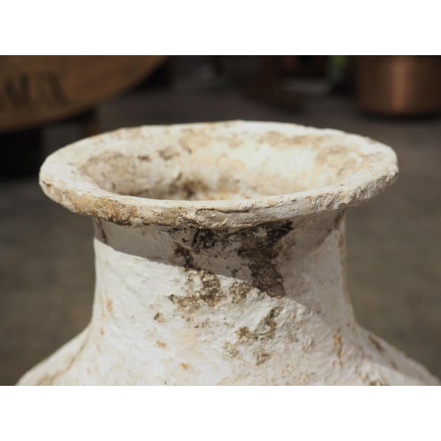 A small pithos (a Greek storage container), this terra cotta jar has well-balanced proportions, with a thin protruding...