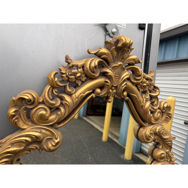 A gorgeous Louis XV Cartouche Rococo Baroque style gilt wood framed wall mirror.