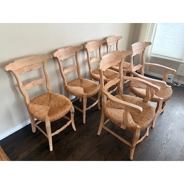 A charming set of six French Country style dining chairs with rustic appeal. The set includes four side chairs and two...