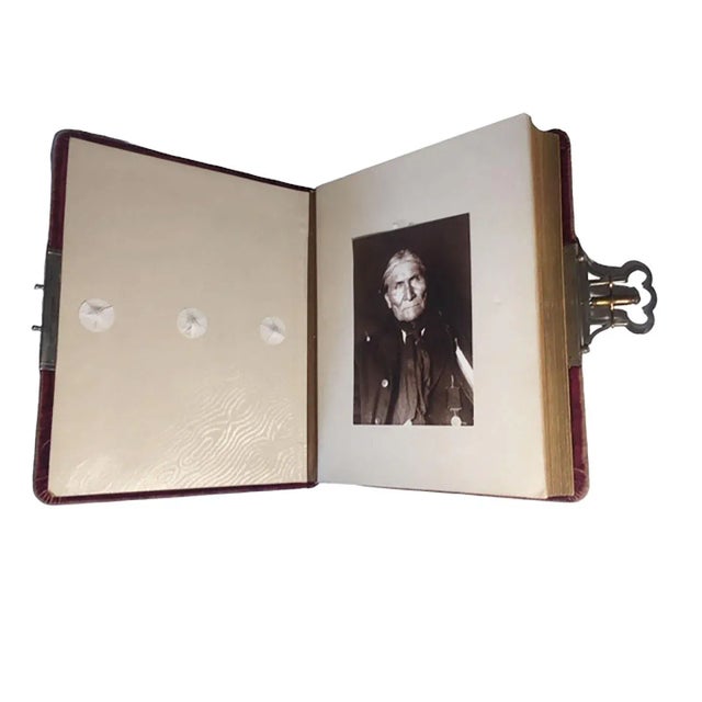 A late 19th century to circa 1900 red velvet photo book with twenty seven old photos of American Indians. The engraved...