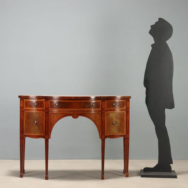 Victorian style sideboard crafted in mahogany, adorned with elegant stringing and inlays in maple and bois de rose. The...