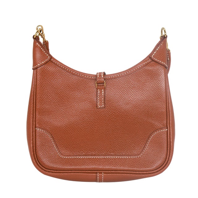 Hermès Gold Courchevel Leather Micro Trim 15cm Bag with Gold Hardware, 1991. Originally introduced in 1958, the Trim bag...