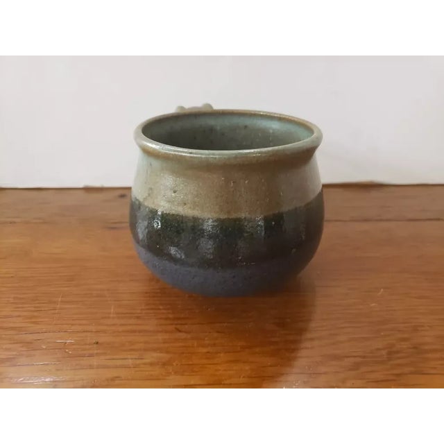 This is a Handmade Stoneware Soup Mug Signed J. Whitcomb. It measures 3 1/8" high, 5 1/4" wide to the handle and 3 5/8“ in...