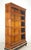 Vintage five section oak barrister bookcase in a medium toned stain. There are two panes of beveled glass and two brass...