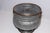 This galvanized metal pot features a graceful bulbous shape with copper-colored rims and decorative rings. Great accent...