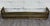 This is a beautiful antique English brass fireplace fender with pierced gallery sides, riveted detailing, and decorative...