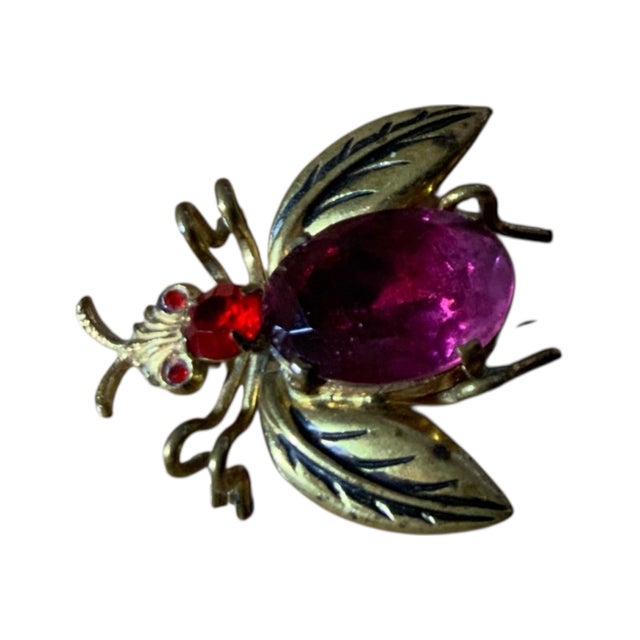 This is a vintage Czech brass pink rhinestone bee bug brooch. It features a gold-tone design with a large oval-shaped...