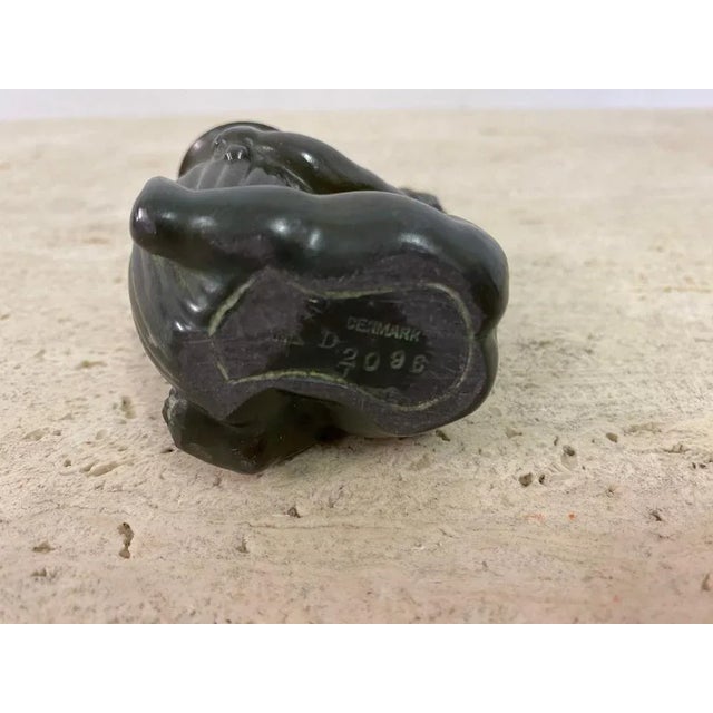 Small Baby figurine holding a vase By Just Andersen Vase acts as a pen holder Made from disco metal Stamped underneath...