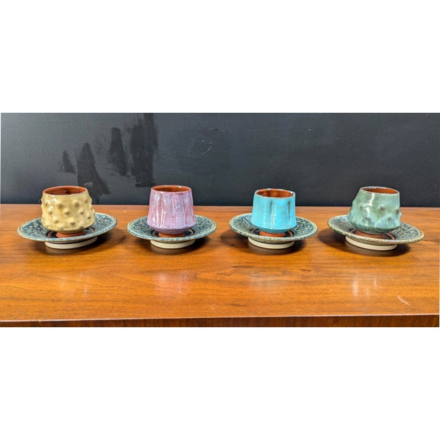 Fun vintage 90s post-modern, hand-made studio pottery set. 4 cups of varying finishes and textures, all similar shape and...