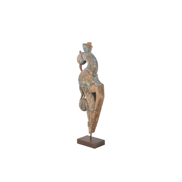 This Antique Indian Carved Teakwood Corbel on a Stand is hand-carved from solid teakwood, featuring a graceful bird form...