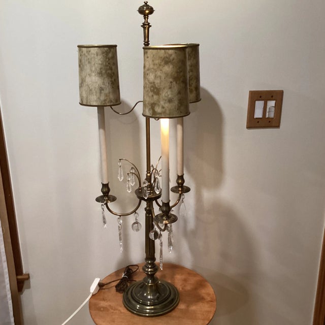 In excellent original condition, these beautiful three-arm lamp made of brass, with hanging crystals. With original cream...