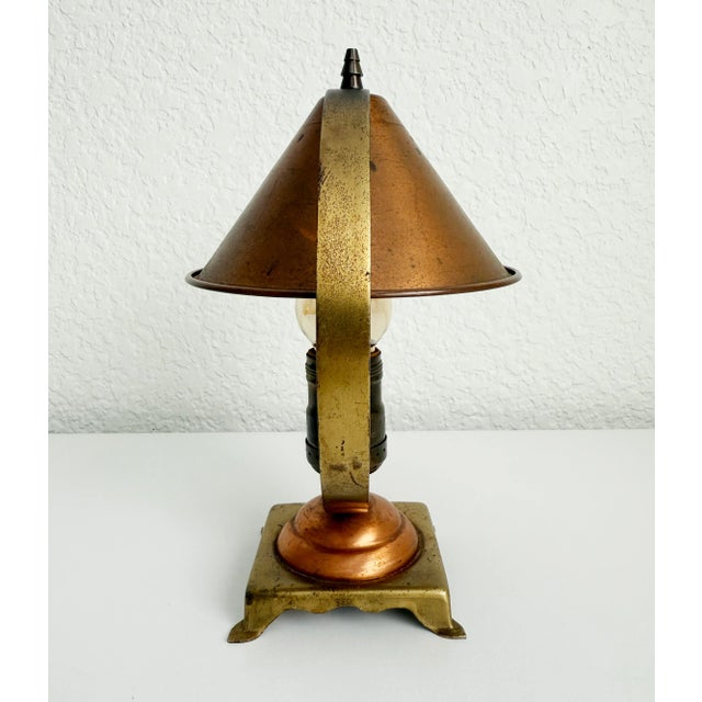 A striking 1930s modernist accent lamp featuring a mix of aged copper and brass. Drawing inspiration from the Art Deco...