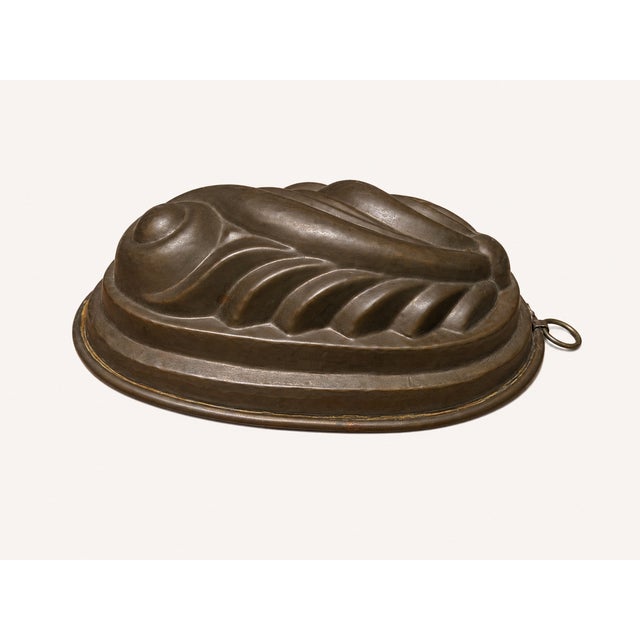 A striking large vintage copper jelly mold featuring a beautifully sculpted fruit and foliate relief in an elegant oval...