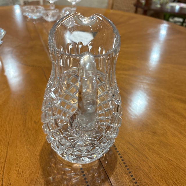 A substantial Waterford crystal water pitcher featuring a classic combination of deep diamond cutting on the lower body...
