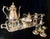This elegant vintage service set features classic silver-plated construction over copper with intricate, ornate detailing...