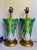 This striking pair of vintage porcelain lamps features sculptural cabbage leaf forms decorated with colorful butterflies...