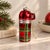 Whimsical figural glass Christmas ornament in the shape of a classic plaid thermos. The glossy red glass body features...