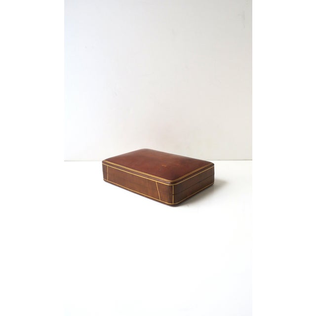 An Italian brown/light‑brown leather box with gold detail, Mid‑Century Modern design, circa mid‑20th century, Italy. A...