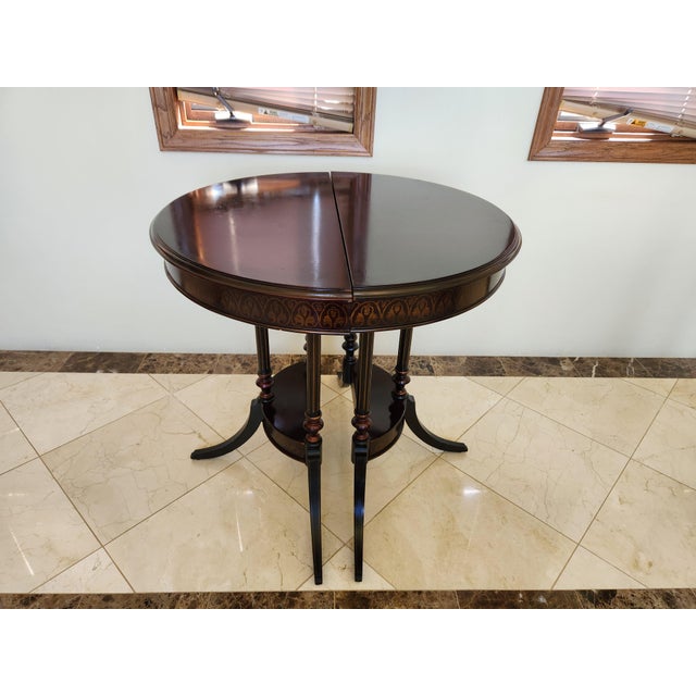 Introduce a touch of refined elegance to your space with this rare and collectible pair of vintage half-round side tables...