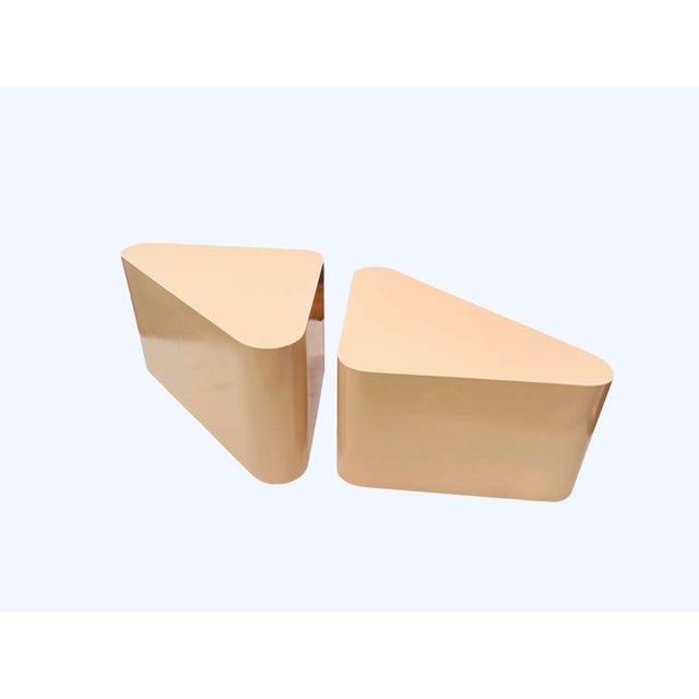 Pair of sculptural 1980s postmodern lacquered coffee tables with an architectural geometric form and concealed casters for...